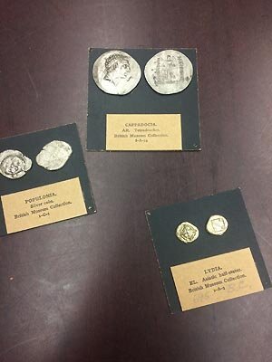 Table top photo with several coins and items in view.